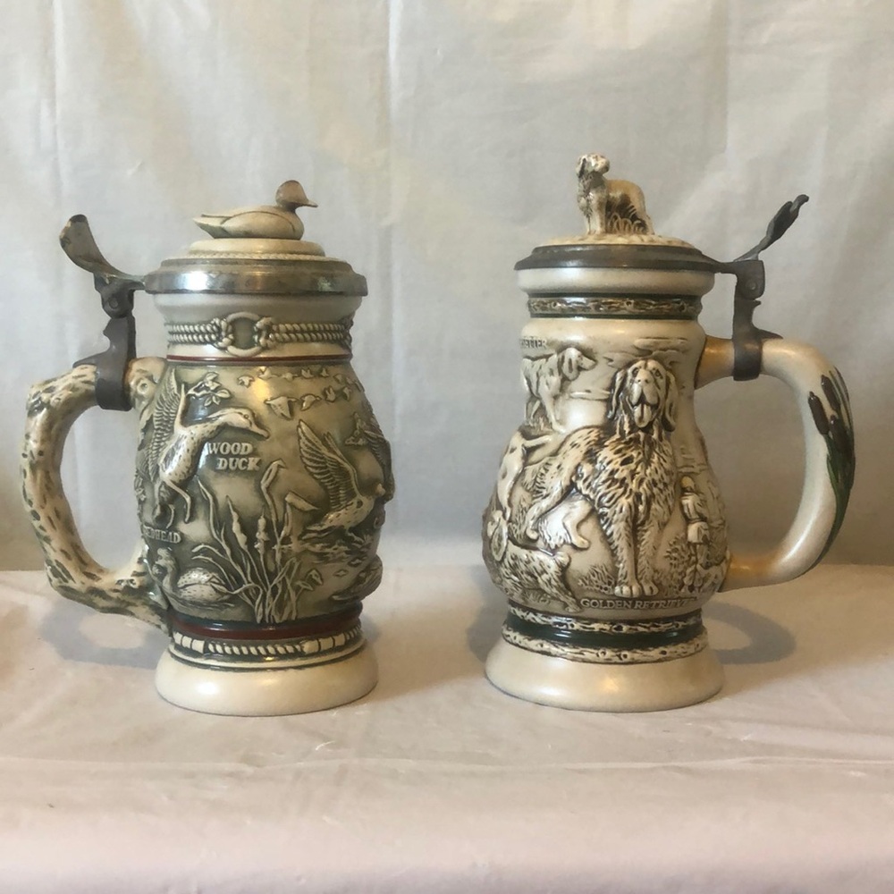Ducks  & hunting dogs Avon beer steins in very good condition- patina on pewter